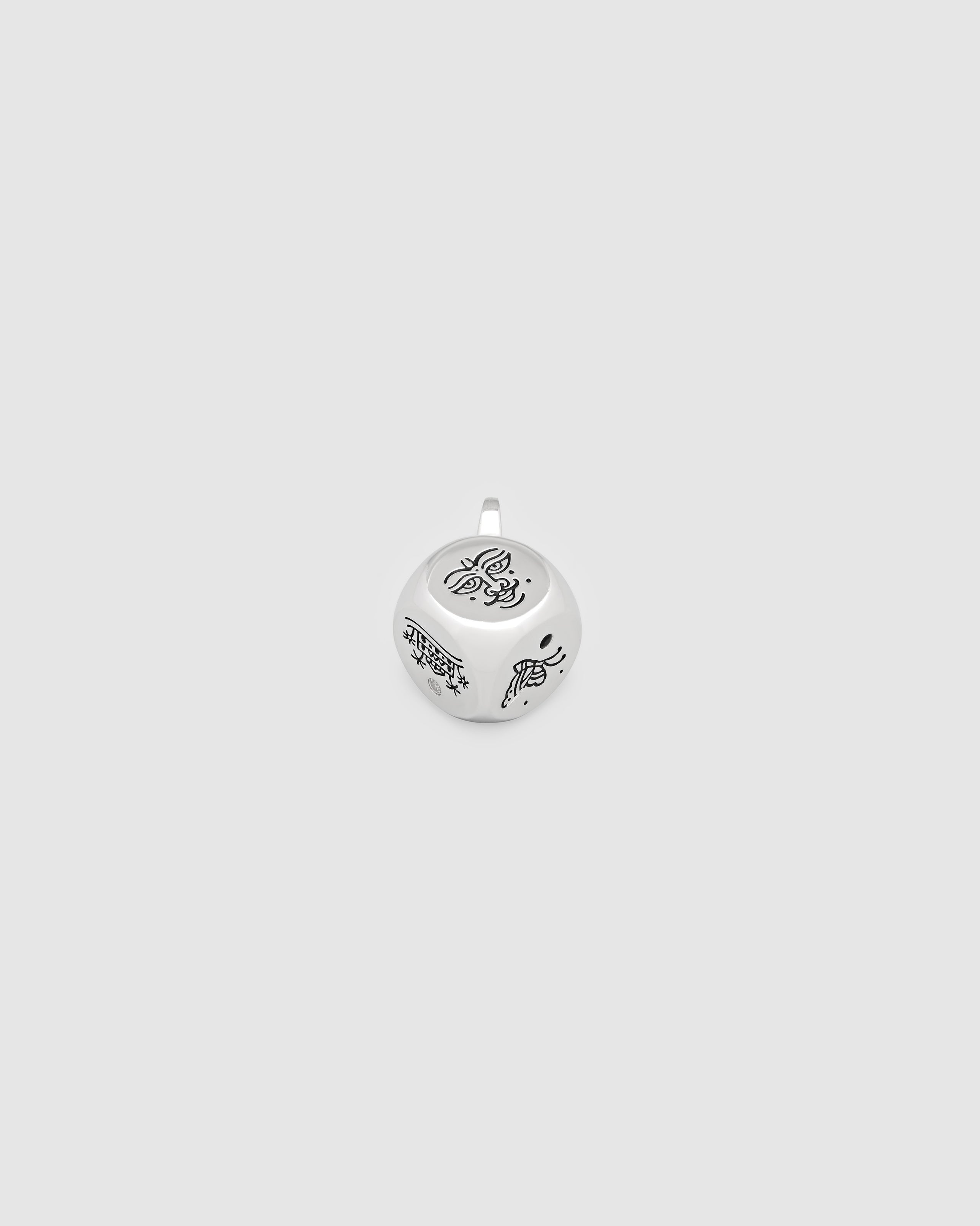 Silver pendant with butterfly design on a light gray background