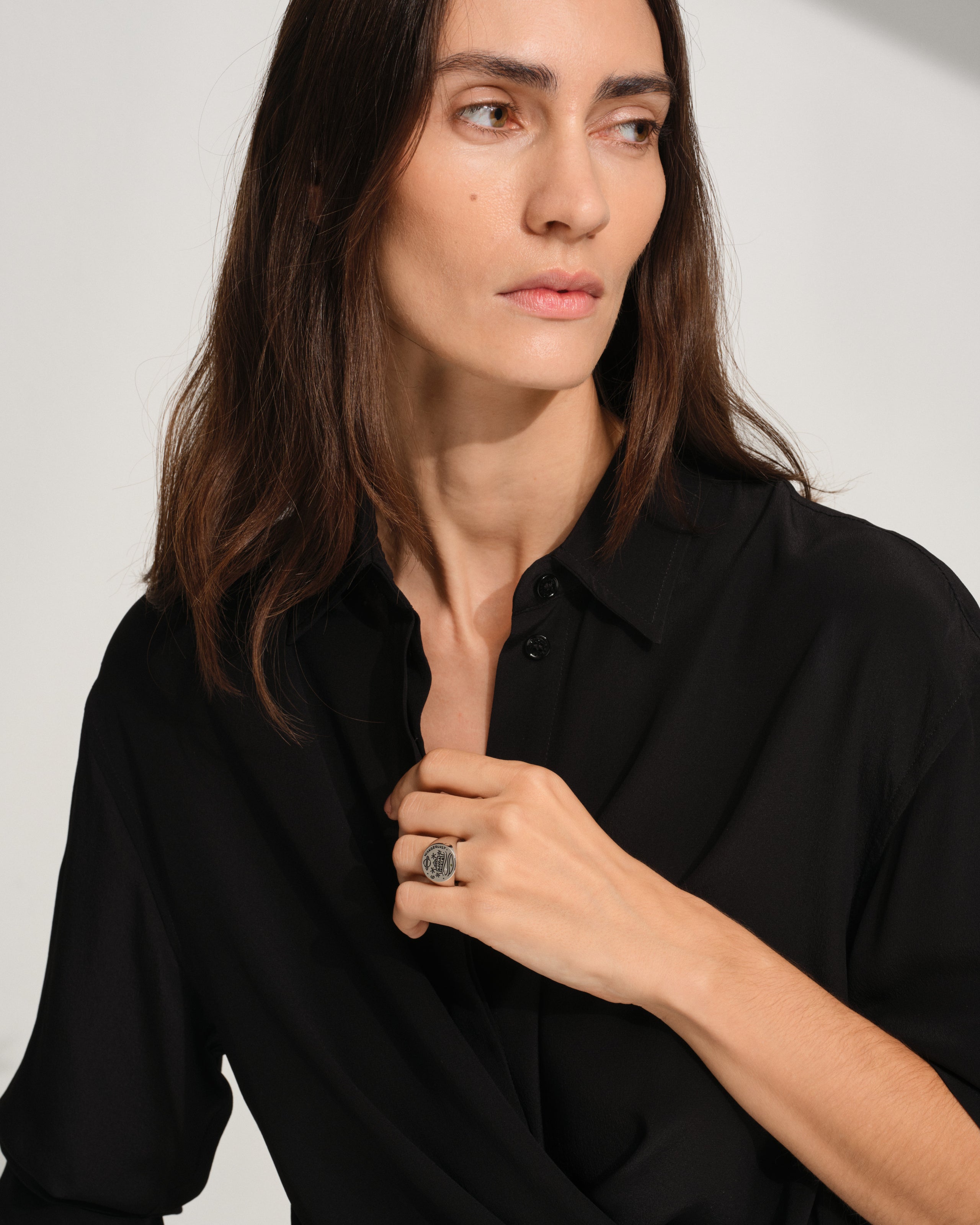 925 sterling silver signet ring with engraved symbols in black antiquing and drawings from Guy Le Tatooeron a white background