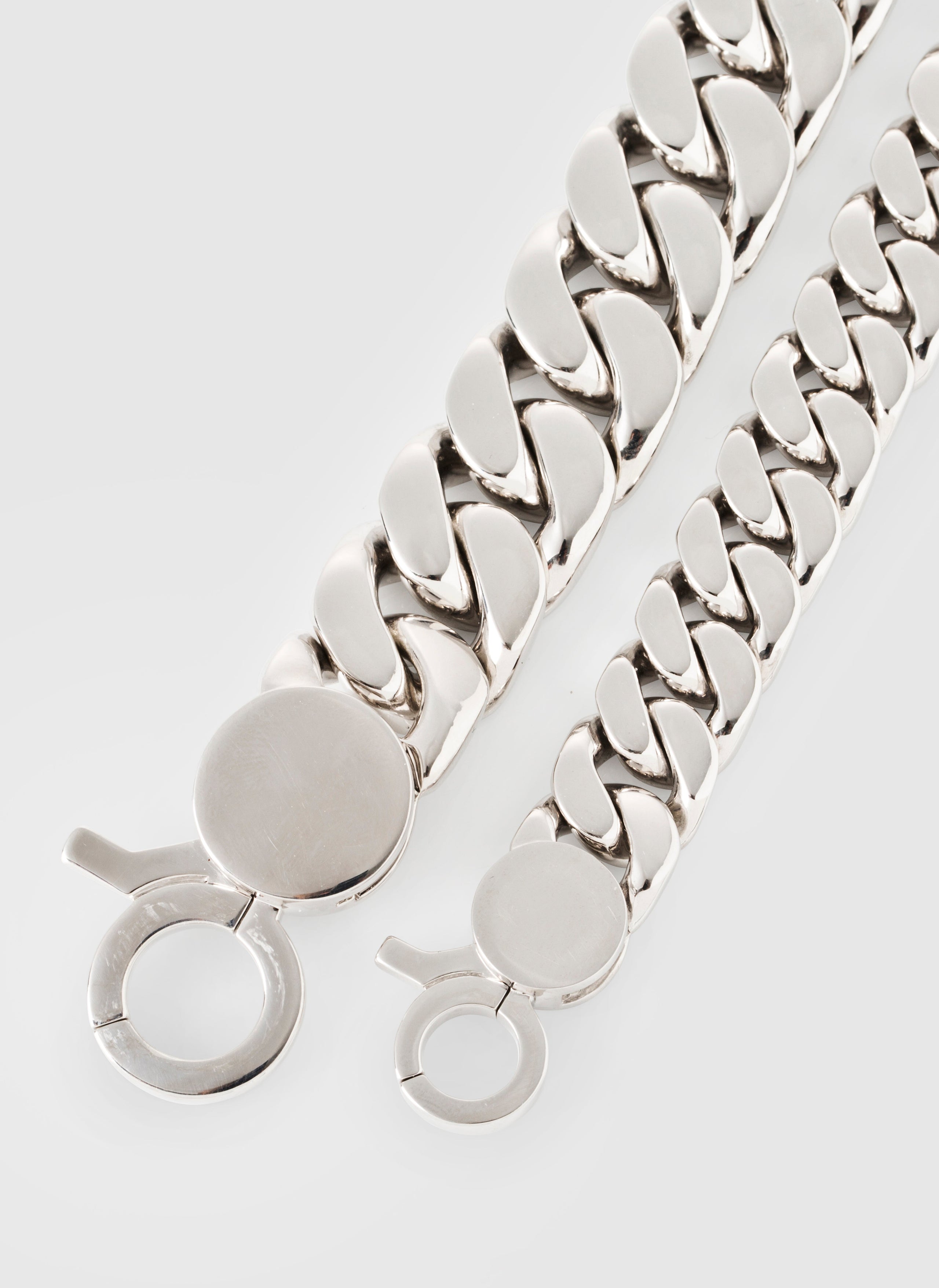 Silver chain bracelet on a light gray background