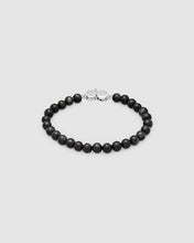 A beaded bracelet made of matte black round beads with a polished silver-toned lobster clasp, displayed on a light gray background.