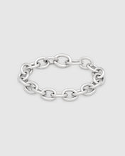 A polished silver chain link bracelet with a flat, wide oval link design, displayed on a light gray background.