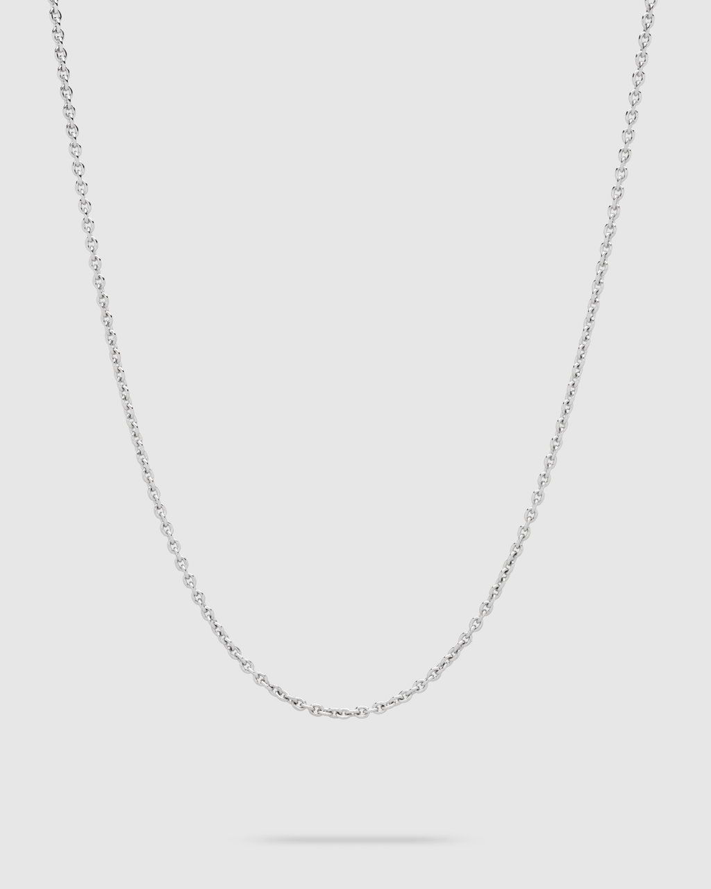 A delicate silver chain necklace with a small-scale link pattern, displayed against a solid light gray background.
