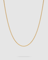 A delicate gold chain necklace with small, uniform links, displayed in a U-shape against a solid light gray background.