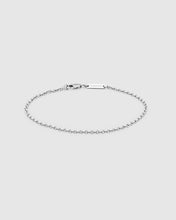 A delicate silver chain bracelet with a lobster clasp and a small rectangular engraved tag, displayed on a light gray background.
