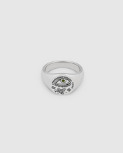 A small, round signet 925 sterling silver ring for men and women, featuring an engraved custom motif by Guy Le Tatooer and a hand-set, deep green tourmaline stone on the surface.