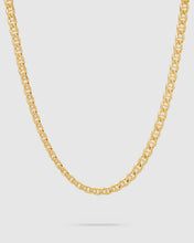 A gold curbed jude chain necklace displayed in a curved shape against a light gray background.